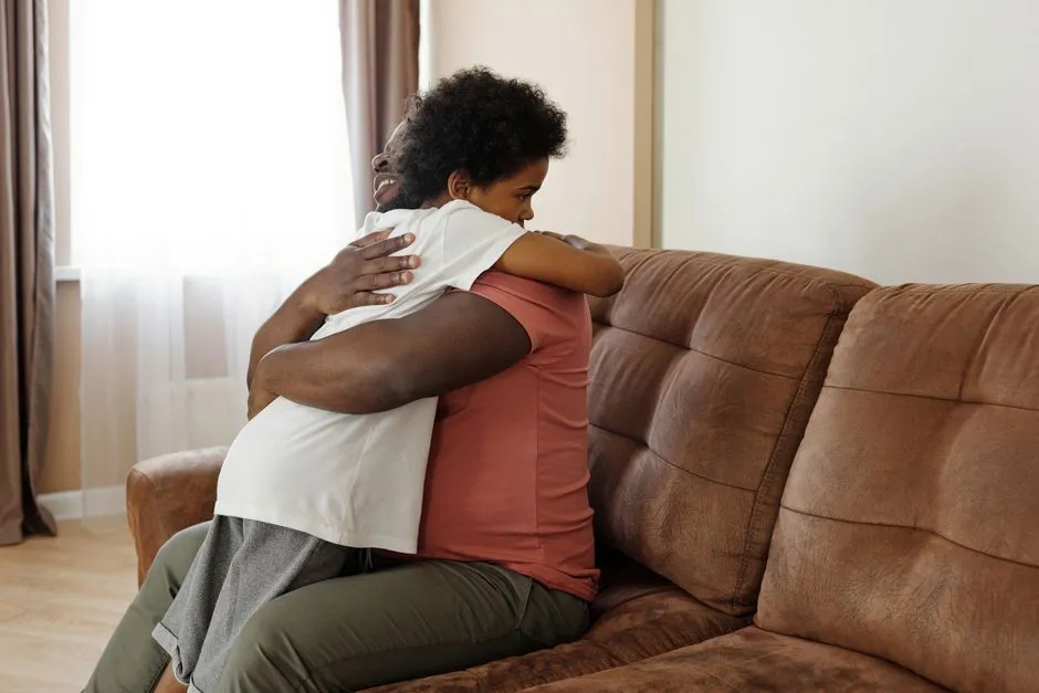 Illustrative photo of a parent embracing a child during a family visit